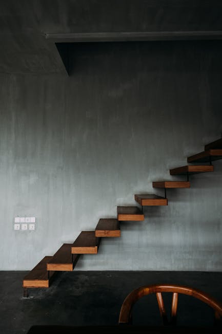 Interior design of wooden stairway in apartment with modern minimalist style with gray walls